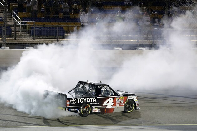 Erik Jones does a burnout after winning the NASCAR Truck Series auto race, Friday, June 19, 2015, at Iowa Speedway in Newton, Iowa. (AP Photo/Charlie Neibergall)