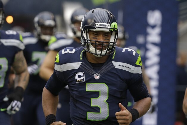 Seattle Seahawks quarterback Russell Wilson (3) runs on the field before an NFL football game against the Carolina Panthers, Sunday, Oct. 18, 2015, in Seattle. (AP Photo/Elaine Thompson)