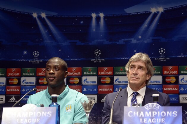 Manchester City's coach Manuel Pellegrini, from Chile, right, and Yaya Toure attend a press conference in Barcelona, Spain, Tuesday, March 17, 2015. FC Barcelona will play against Manchester City in a Champions League match on Wednesday March 18. (AP Photo/Manu Fernandez)