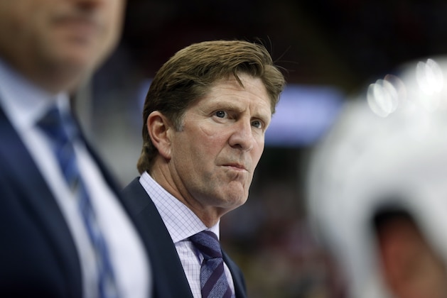 Toronto Maple Leafs head coach Mike Babcock watches from the bench against the Detroit Red Wings in the first period of a NHL hockey game in Detroit Friday, Oct. 2, 2015. (AP Photo/Paul Sancya)