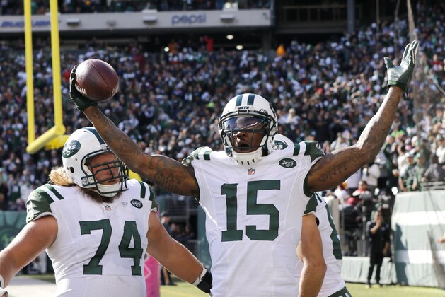 New York Jets wide receiver Brandon Marshall (15) celebrates with teammates Nick Mangold (74) and Eric Decker (87) after scoring on a touchdown pass from quarterback Ryan Fitzpatrick, not pictured, during the second half of an NFL football game against the Washington Redskins, Sunday, Oct. 18, 2015, in East Rutherford, N.J. (AP Photo/Gary Hershorn)