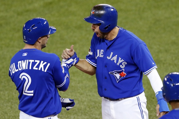 Toronto Blue Jays' Troy Tulowitzki celebrates his two run home run with Chris Colabello during the third inning in Game 3 of baseball's American League Championship Series against the Kansas City Royals on Monday, Oct. 19, 2015, in Toronto. (AP Photo/Paul Sancya)