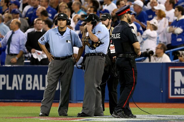 TORONTO, ON - OCTOBER 14:  Home plate umpire Dale Scott calls in for a replay in the seventh inning in game five of the American League Division Series at Rogers Centre on October 14, 2015 in Toronto, Canada.  (Photo by Vaughn Ridley/Getty Images)