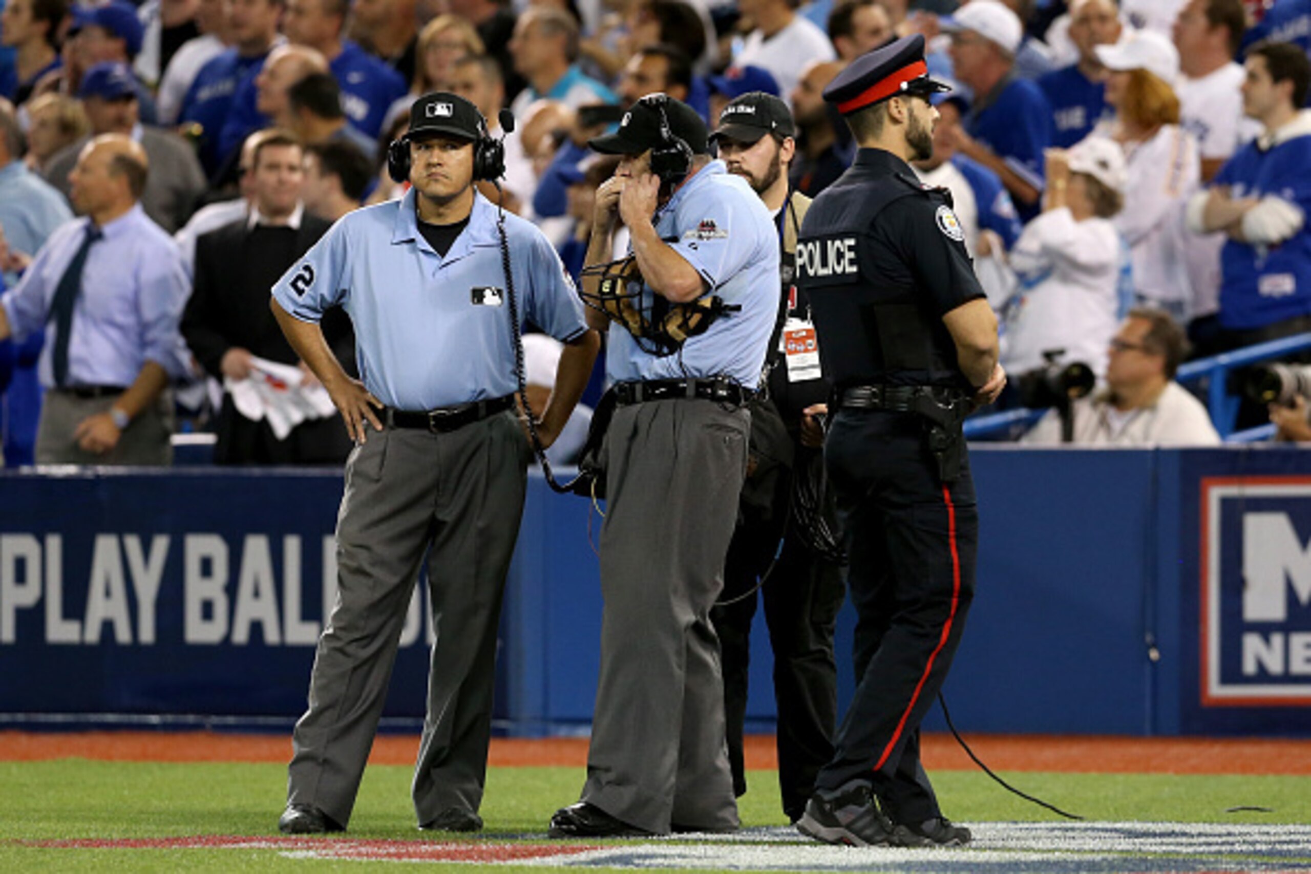 TORONTO, ON - OCTOBER 14:  Home plate umpire Dale Scott calls in for a replay in the seventh inning in game five of the American League Division Series at Rogers Centre on October 14, 2015 in Toronto, Canada.  (Photo by Vaughn Ridley/Getty Images)