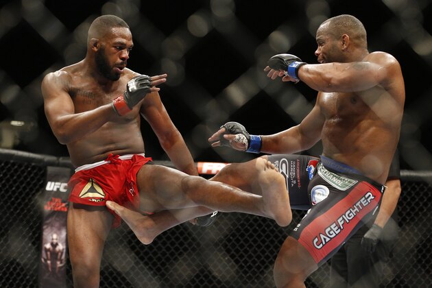 Daniel Cormier, right, kicks Jon Jones during their light heavyweight title mixed martial arts bout at UFC 182, Saturday, Jan. 3, 2015, in Las Vegas. (AP Photo/John Locher)