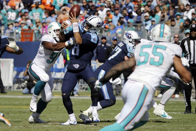 Tennessee Titans quarterback Marcus Mariota (8) fumbles the ball as he is hit by Miami Dolphins defensive end Cameron Wake (91) in the first half of an NFL football game Sunday, Oct. 18, 2015, in Nashville, Tenn. The Dolphins recovered the ball. (AP Photo/James Kenney)