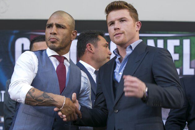 Boxers Miguel Cotto, from Puerto Rico, left, WBC, Ring Magazine and Lineal Middleweight World Champion and Saul