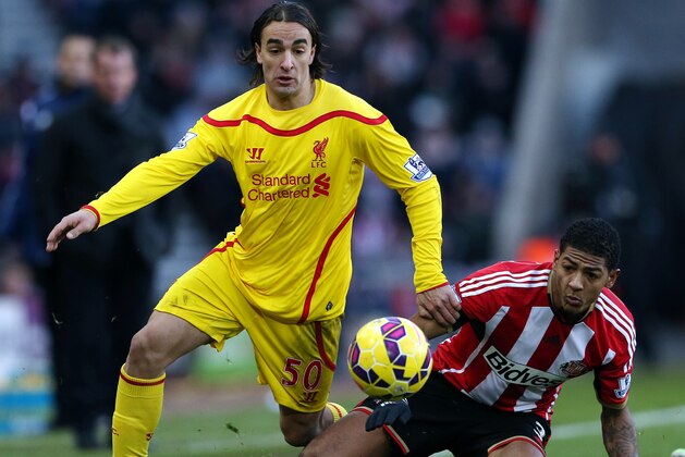 Liverpool's Lazar Markovic, left, vies for the ball with Sunderland's Patrick Van Aanholt, right, during their English Premier League soccer match at the Stadium of Light, Sunderland, England, Saturday, Jan. 10, 2015. (AP Photo/Scott Heppell)