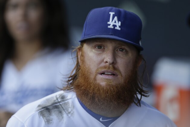 Los Angeles Dodgers third baseman Justin Turner looks on in the dugout before Game 5 of baseball's National League Division Series between the Dodgers and the New York Mets  Thursday, Oct. 15, 2015, in Los Angeles. (AP Photo/Alex Gallardo)