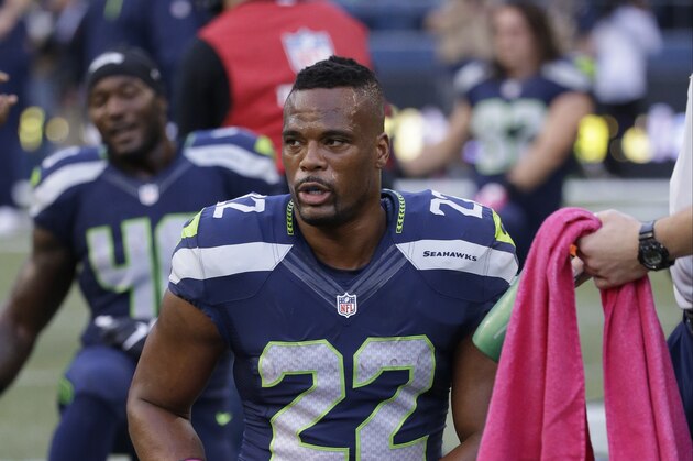Seattle Seahawks running back Fred Jackson (22) wears pink gloves and other items for breast cancer awareness before an NFL football game against the Detroit Lions, Monday, Oct. 5, 2015, in Seattle. (AP Photo/Elaine Thompson)