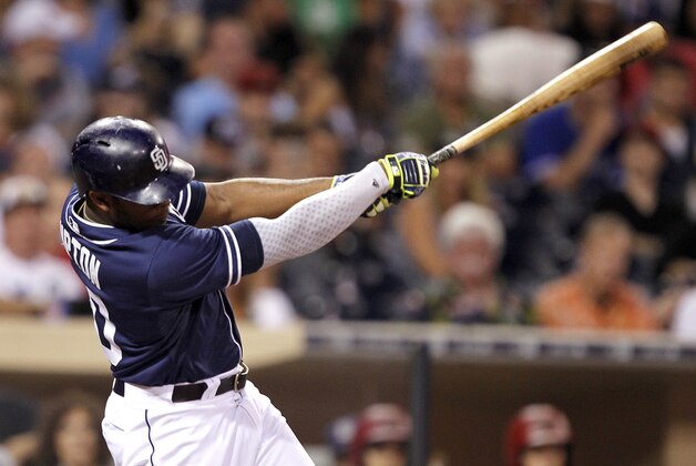 San Diego Padres' Justin Upton hits a double to score Cory Spangenberg during the eighth inning of a baseball game against the Arizona Diamondbacks in San Diego, Saturday, Sept. 26, 2015. (AP Photo/Alex Gallardo)