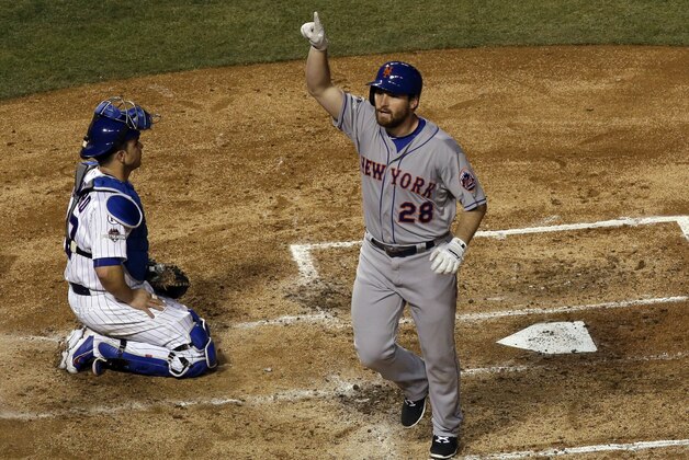 New York Mets' Daniel Murphy celebrates after hitting a home run during the third inning of Game 3 of the National League baseball championship series against the Chicago Cubs Tuesday, Oct. 20, 2015, in Chicago. (AP Photo/David J. Phillip)