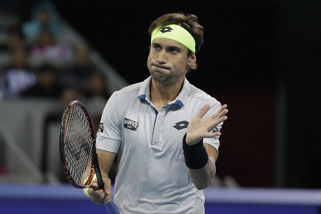 David Ferrer of Spain reacts after missing a point to Novak Djokovic of Serbia during their men's singles semifinals match of the China Open tennis tournament at the National Tennis Stadium in Beijing, Saturday, Oct. 10, 2015. (AP Photo/Andy Wong)