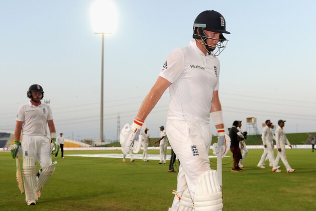 ABU DHABI, UNITED ARAB EMIRATES - OCTOBER 17:  Joe Root and Ian Bell of England leave the field after bad light stops play on day five of the 1st Test between Pakistan and England at Zayed Cricket Stadium on October 17, 2015 in Abu Dhabi, United Arab Emirates.  (Photo by Gareth Copley/Getty Images)