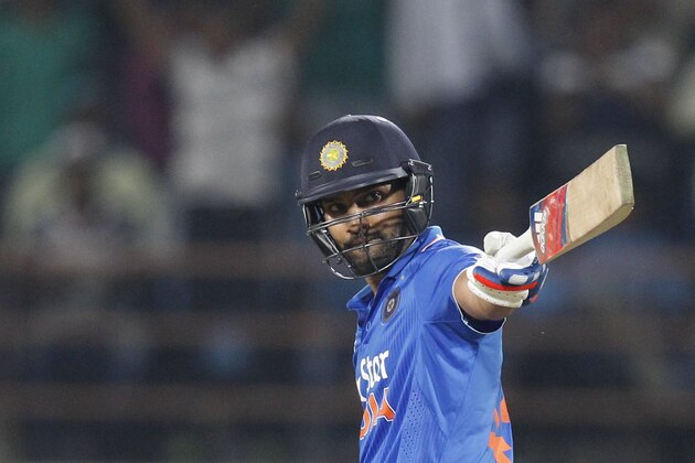 India's Rohit Sharma acknowledges his fifty runs during their third one-day international cricket match against South Africa in Rajkot, India, Sunday, Oct. 18, 2015. (AP Photo/Ajit Solanki)