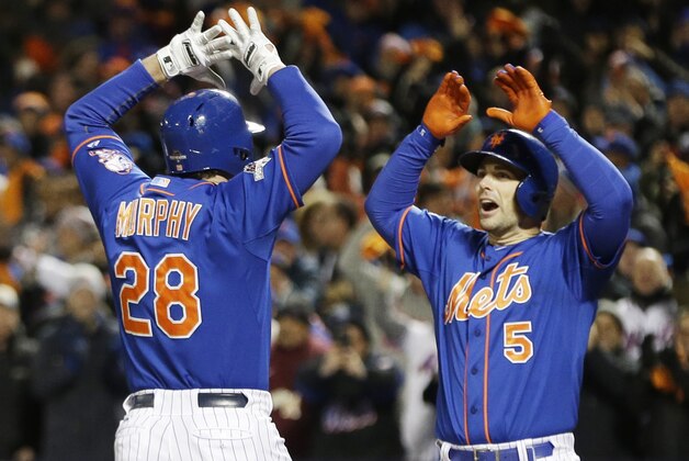 New York Mets' Daniel Murphy is congratulated by teammate David Wright after hitting a two-run home run during the first inning of Game 2 of the National League baseball championship series against the Chicago Cubs Sunday, Oct. 18, 2015, in New York. (AP Photo/David J. Phillip)