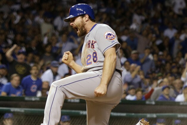 New York Mets' Daniel Murphy reacts after scoring during the seventh inning of Game 3 of the National League baseball championship series against the Chicago Cubs Tuesday, Oct. 20, 2015, in Chicago. Murphy scored from third on a ball hit by Lucas Duda. (AP Photo/David J. Phillip)