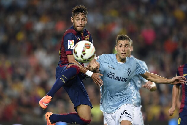 Barcelona's Brazilian forward Neymar da Silva Santos Junior (L) vies with Eibar's defender Raul Albentosa (R) during the Spanish league football match FC Barcelona vs Eibar at the Camp Nou stadium in Barcelona on October 18, 2014.   AFP PHOTO/ LLUIS GENE        (Photo credit should read LLUIS GENE/AFP/Getty Images)