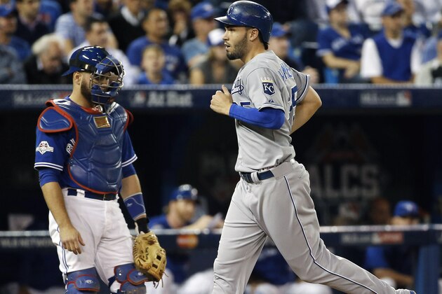 Kansas City Royals' Eric Hosmer scores past Toronto Blue Jays catcher Russell Martin on a sacrifice fly ball during the first inning in Game 4 of baseball's American League Championship Series on Tuesday, Oct. 20, 2015, in Toronto. (AP Photo/Matt Slocum)