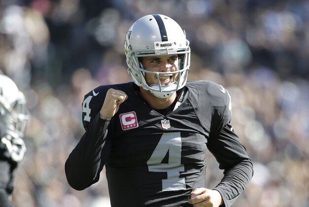 Oakland Raiders quarterback Derek Carr (4) celebrates after throwing a touchdown pass to fullback Marcel Reece during the first half of an NFL football game against the Denver Broncos in Oakland, Calif., Sunday, Oct. 11, 2015. (AP Photo/Marcio Jose Sanchez)