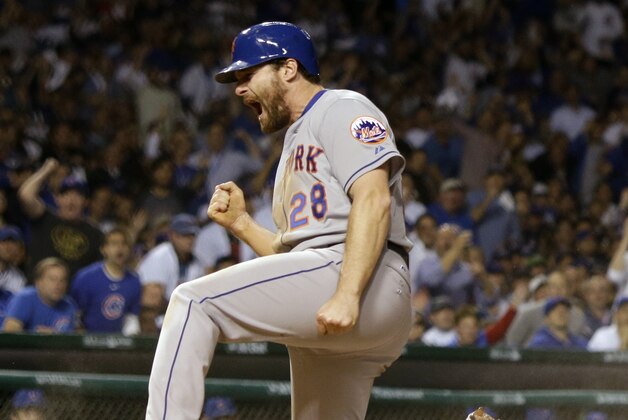 New York Mets' Daniel Murphy reacts after scoring during the seventh inning of Game 3 of the National League baseball championship series against the Chicago Cubs Tuesday, Oct. 20, 2015, in Chicago. Murphy scored from third on a ball hit by Lucas Duda. (AP Photo/David J. Phillip)