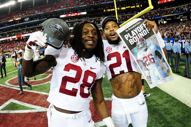 ATLANTA, GA - DECEMBER 06:  Altee Tenpenny #28 and Maurice Smith #21 of the Alabama Crimson Tide celebrate their 42 to 13 win over the Missouri Tigers in the SEC Championship game at the Georgia Dome on December 6, 2014 in Atlanta, Georgia.  (Photo by Scott Cunningham/Getty Images)