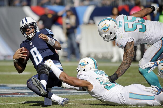 Tennessee Titans quarterback Marcus Mariota (8) is sacked by Miami Dolphins defensive end Olivier Vernon (50) in the first half of an NFL football game Sunday, Oct. 18, 2015, in Nashville, Tenn. (AP Photo/James Kenney)