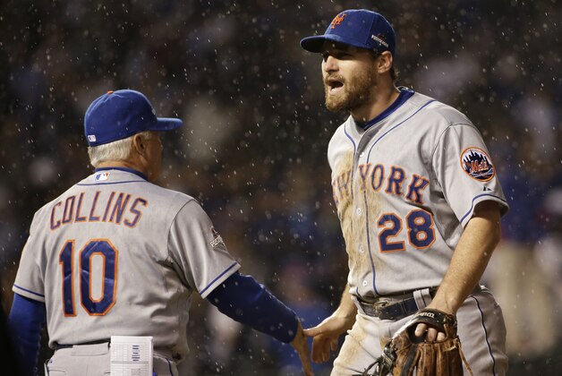 New York Mets' Daniel Murphy (28) is congratulated by manager Terry Collins after Game 3 of the National League baseball championship series against the Chicago Cubs Tuesday, Oct. 20, 2015, in Chicago. The Mets won 5-2 to take a 3-0 lead in the series. (AP Photo/David J. Phillip)