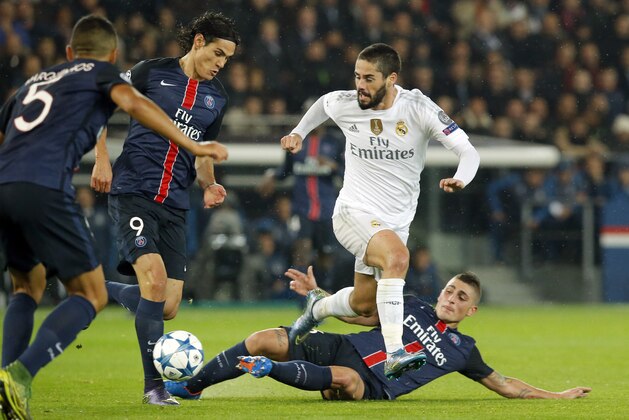 Real Madrid's Isco, right, challenges for the ball with PSG players Marquinhos, left,  Edinson Cavani, 2nd left, and Marco Verratti, on ground, during the Champions League group A soccer match between Paris St Germain and Real Madrid at the Parc des Princes stadium in Paris, Wednesday, Oct. 21, 2015. (AP Photo/Michel Euler)