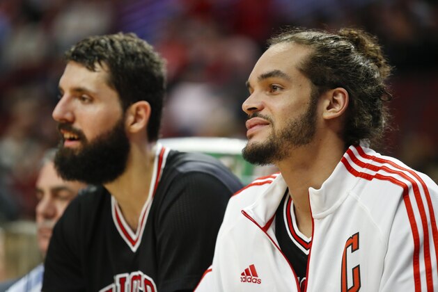 Chicago Bulls forward Nikola Mirotic (44) and center Joakim Noah (13) sit on the bench during the second half of an NBA basketball game against the New York Knicks, Saturday, March 28, 2015, in Chicago. The Bulls won 111-80. (AP Photo/Kamil Krzaczynski)