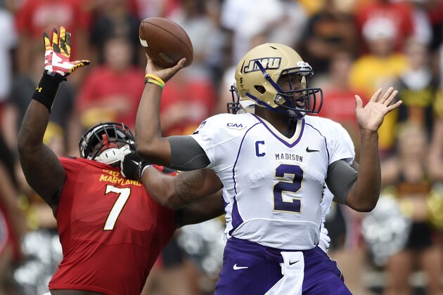 James Madison quarterback Vad Lee (2) looks to pass as he is pressured by Maryland linebacker Yannick Ngakoue (7) during the first half of an NCAA college football game, Saturday, Aug. 30, 2014, in College Park, Md. (AP Photo/Nick Wass)