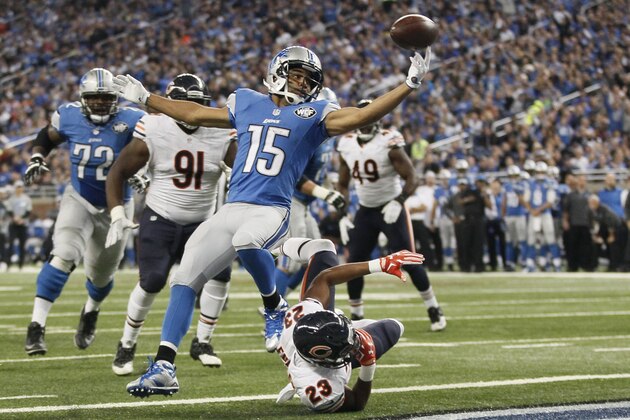 Detroit Lions wide receiver Golden Tate (15) reaches for the ball after Chicago Bears cornerback Kyle Fuller (23) knocked the ball away after Tate crossed the goal line for a touchdown during the first half of an NFL football game, Sunday, Oct. 18, 2015, in Detroit. (AP Photo/Duane Burleson)