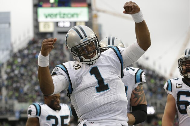 Carolina Panthers quarterback Cam Newton reacts after he rushed for a touchdown in the first half of an NFL football game against the Seattle Seahawks, Sunday, Oct. 18, 2015, in Seattle. (AP Photo/Elaine Thompson)