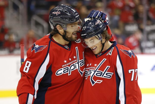 Oct 15, 2015; Washington, DC, USA; Washington Capitals right wing T.J. Oshie (77) celebrates with Capitals left wing Alex Ovechkin (8) after scoring a goal against the Chicago Blackhawks in the first period at Verizon Center. Mandatory Credit: Geoff Burke-USA TODAY Sports