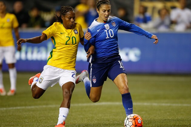 SEATTLE, WA - OCTOBER 21:  Carli Lloyd #10 of the United States dribbles against Formiga #20 of Brazil at CenturyLink Field on October 21, 2015 in Seattle, Washington.  (Photo by Otto Greule Jr/Getty Images)
