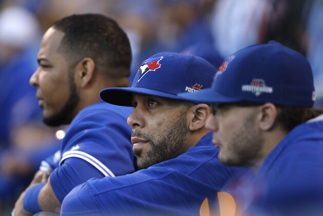 Toronto Blue Jays starting pitcher David Price, center, watches the eighth inning of Game 2 of baseball's American League Championship Series against the Kansas City Royals, Saturday, Oct. 17, 2015, in Kansas City, Mo. (AP Photo/Matt Slocum)
