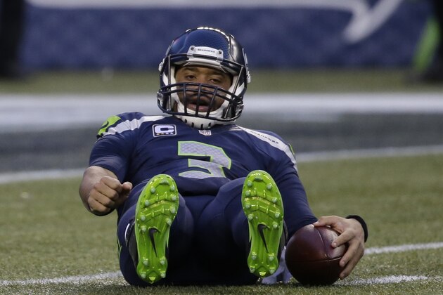 Seattle Seahawks quarterback Russell Wilson gets up after a play against the San Francisco 49ers in the second half of an NFL football game, Sunday, Dec. 14, 2014, in Seattle. (AP Photo/Elaine Thompson)