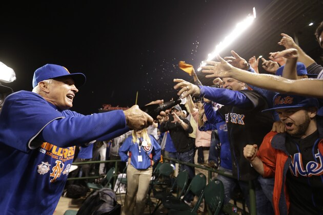 New York Mets manager Terry Collins sprays some fans after Game 4 of the National League baseball championship series against the Chicago Cubs Wednesday, Oct. 21, 2015, in Chicago. The Mets won 8-3 to advance to the World Series. (AP Photo/David Goldman) New York Mets manager Terry Collins sprays some fans after Game 4 of the National League baseball championship series against the Chicago Cubs Wednesday, Oct. 21, 2015, in Chicago. The Mets won 8-3 to advance to the World Series. (AP Photo/David Goldman)