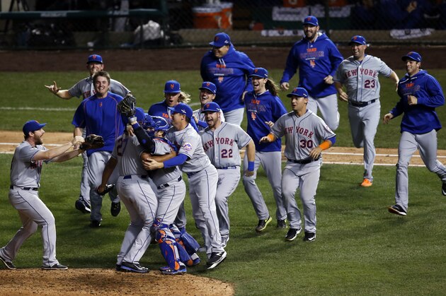 The New York Mets celebrate after Game 4 of the National League baseball championship series against the Chicago Cubs Wednesday, Oct. 21, 2015, in Chicago. The Mets won 8-3 to advance to the World Series. (AP Photo/Charles Rex Arbogast)