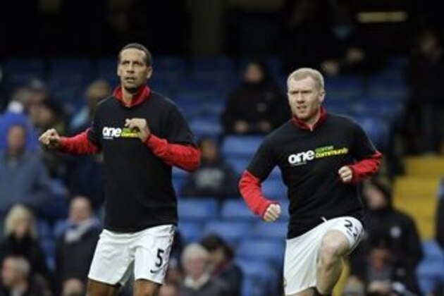 Manchester United's Rio Ferdinand, left, Paul Scholes, centre, and Wayne Rooney, right, wear anti-racism t-shirts ahead of the English Premier League soccer match between Chelsea and Manchester United at Stamford Bridge Stadium in London, Sunday, Oct. 28, 2012. (AP Photo/Kirsty Wigglesworth)