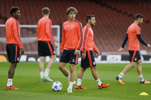 Bayern's Gianluca Gaudino, center, controls the ball during a soccer training session at Emirates stadium in London Monday, Oct. 19, 2015. Arsenal will play Bayern Munich in a Champions League Group F soccer match at the stadium on Tuesday. (AP Photo/Kirsty Wigglesworth)