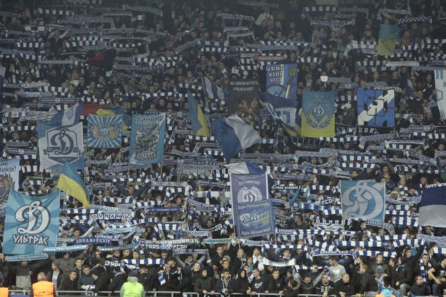 Supporters of Dynamo Kiev hold flags and scarves prior the Champions League Group G soccer match against Chelsea at the Olympiyskiy Stadium in Kiev, Ukraine, Tuesday, Oct. 20, 2015. (AP Photo/Efrem Lukatsky)
