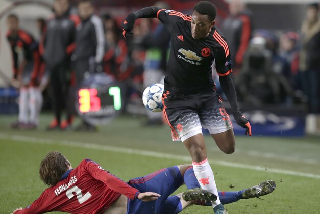 Manchester United's Anthony Martial, right, is challenged by CSKA's Mario Fernandes, left, during Champions League Group B soccer match between CSKA Moscow and Manchester United at the Arena Khimki stadium in Moscow, Russia, on Wednesday, Oct. 21, 2015. (AP Photo/Pavel Golovkin)