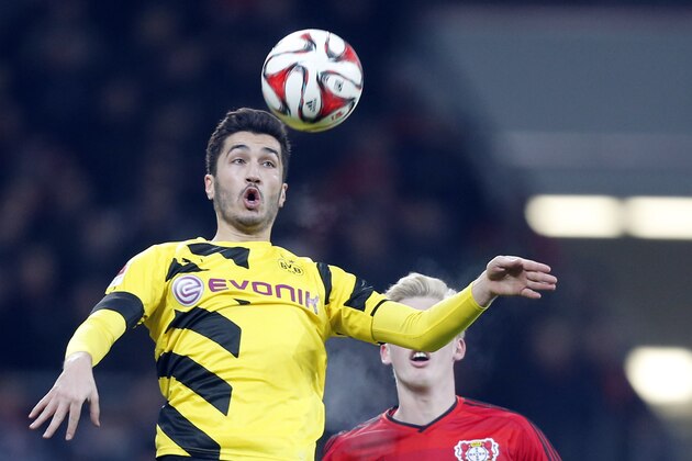 Dortmund's Nuri Sahin, left, and Leverkusen's Julian Brandt challenge for the ball during the German first division Bundesliga soccer match between Bayer 04 Leverkusen and BvB Borussia Dortmund in Leverkusen, Germany, Saturday, Jan. 31, 2015. (AP Photo/Frank Augstein)
