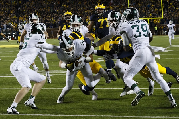 Oct 17, 2015; Ann Arbor, MI, USA; Michigan State Spartans defensive back Jalen Watts-Jackson (20) dives into the end zone for a game winning touchdown as the clock runs out in the fourth quarter against the Michigan Wolverines at Michigan Stadium. Michigan State 27-23. Mandatory Credit: Rick Osentoski-USA TODAY Sports