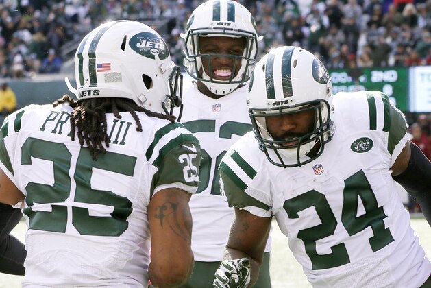 New York Jets players celebrate with cornerback Darrelle Revis after he intercepted a pass during the second half of an NFL football game against the Washington Redskins, Sunday, Oct. 18, 2015, in East Rutherford, N.J. (AP Photo/Gary Hershorn)