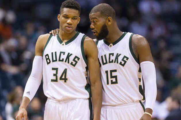 Oct 10, 2015; Milwaukee, WI, USA; Milwaukee Bucks center Greg Monroe (15) talks with forward Giannis Antetokounmpo (34) during the second quarter against the Detroit Pistons at BMO Harris Bradley Center. Mandatory Credit: Jeff Hanisch-USA TODAY Sports