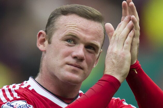 Manchester United's Wayne Rooney applauds supporters after the English Premier League soccer match between Manchester United and Sunderland at Old Trafford Stadium, Manchester, England, Saturday, Sept. 26, 2015. (AP Photo/Jon Super)