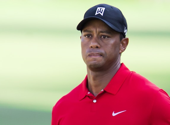 Tiger Woods watches a chip shot to the 15th green during the final round of the Wyndham Championship golf tournament at Sedgefield Country Club in Greensboro, N.C., Sunday, Aug. 23, 2015. (AP Photo/Rob Brown)