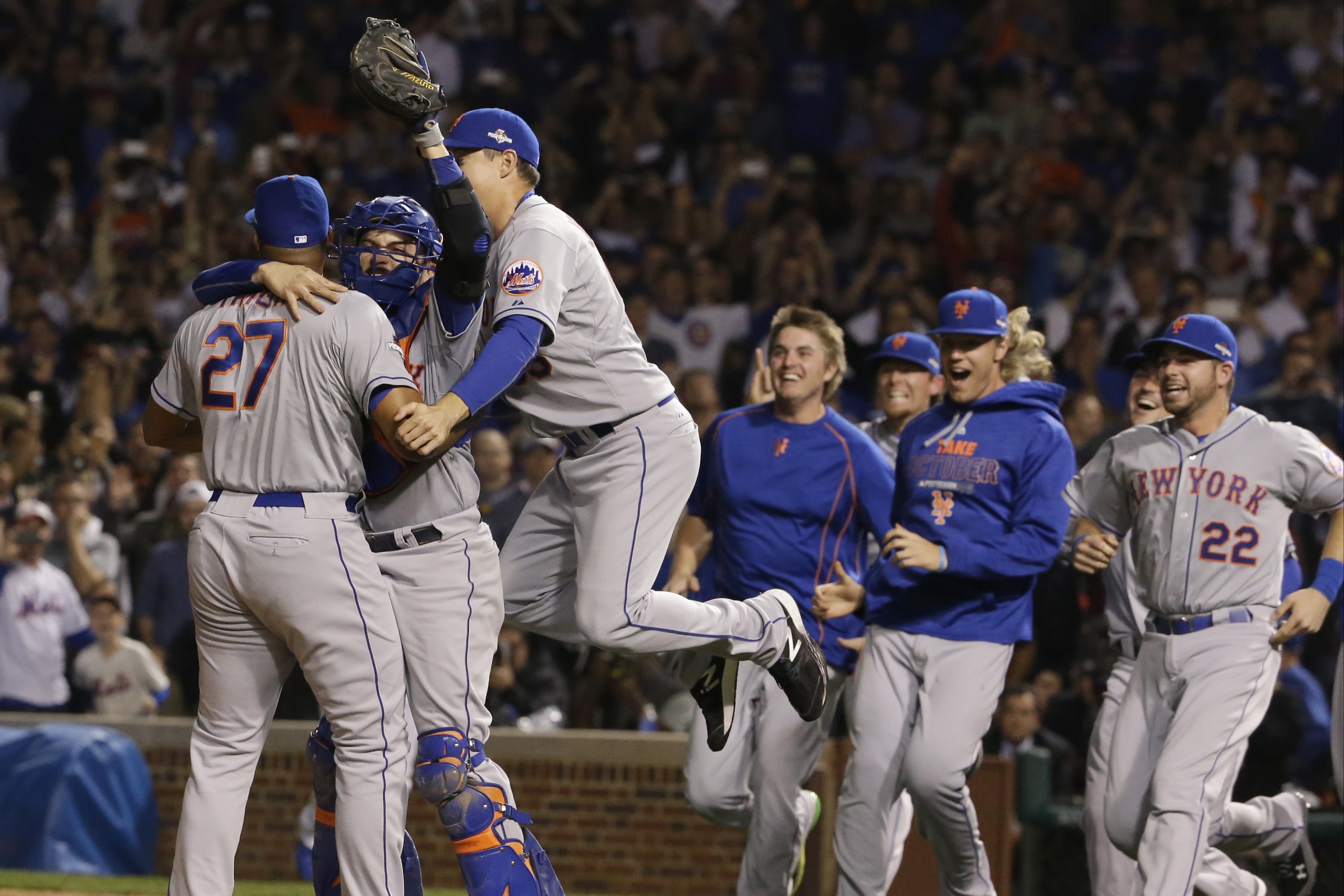 The New York Mets celebrate after Game 4 of the National League baseball championship series against the Chicago Cubs Wednesday, Oct. 21, 2015, in Chicago. The Mets won 8-3 to advance to the World Series. (AP Photo/Nam Y. Huh)